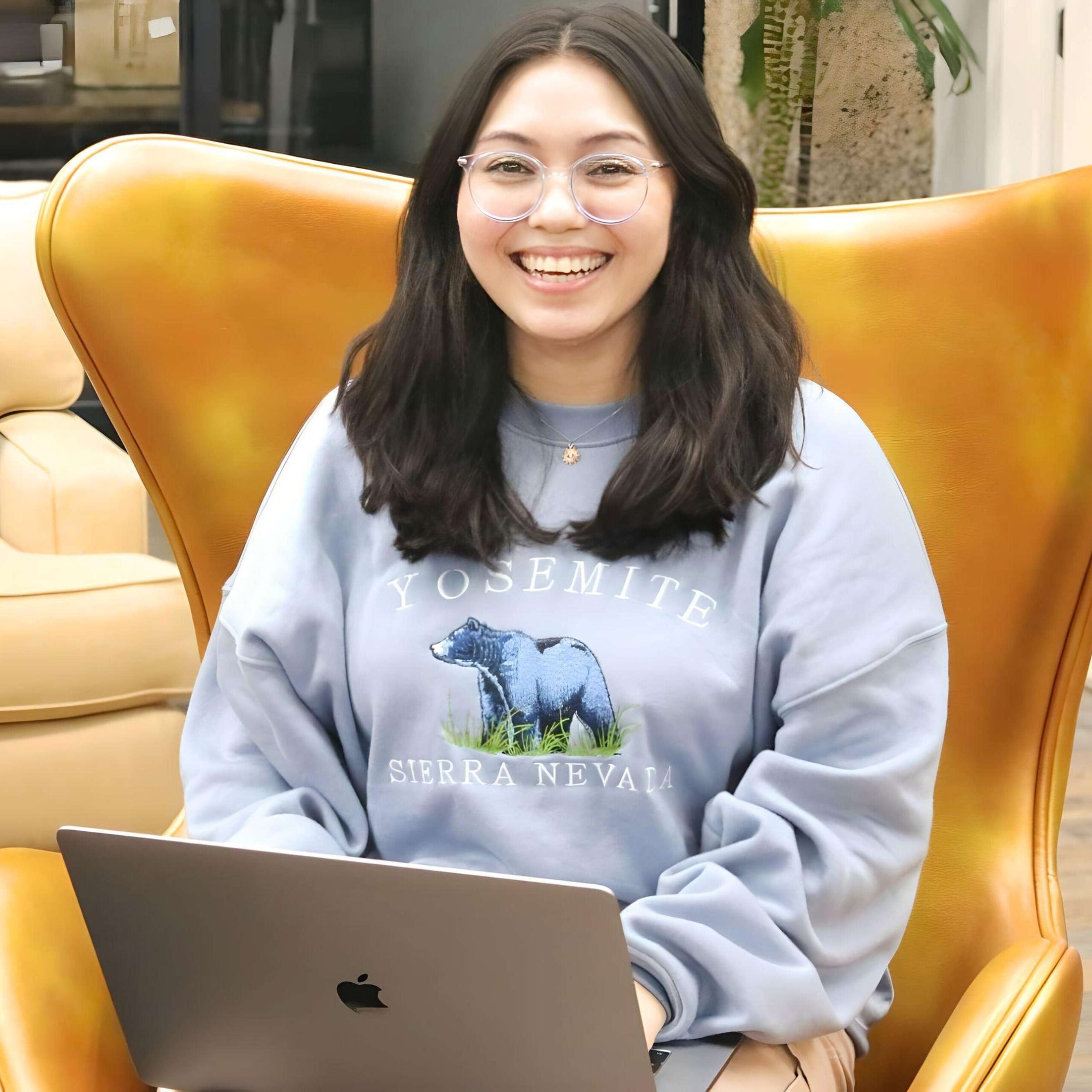 Professional portrait of Casey Durazo, Board Member of Creating Coding Careers, with a confident expression against a vibrant pink background, reflecting her dynamic leadership and commitment to diversity in tech.